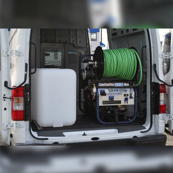 A view inside a Mansfield Sanitation van filled with drain cleaning equipment.