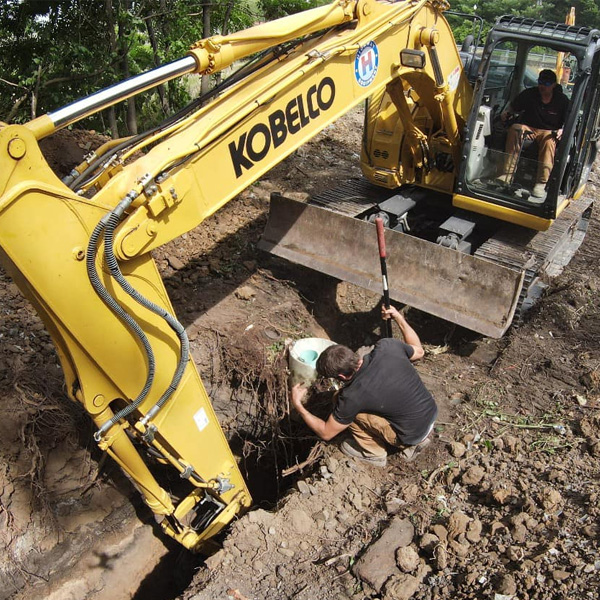 An excavator digging a hole.